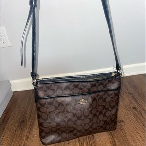 Brown Coach crossbody with black trim
